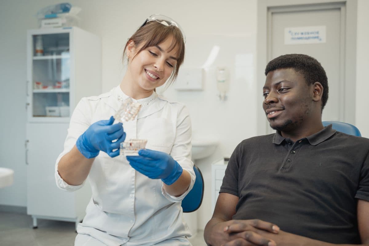 Dentist explaining a root canal treatment plan to a relaxed patient in Sanpada